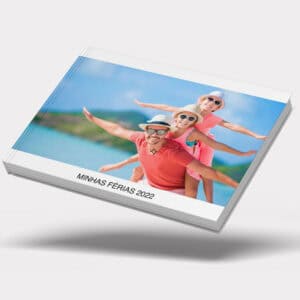 Familia feliz curtindo férias na praia com álbum personalizado Uniko 2022.